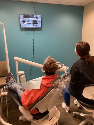 Dr. Annie reviewing X-rays with a patient