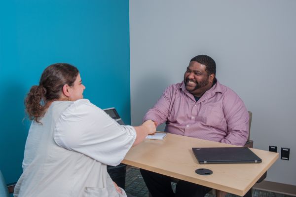 mental health counselor greeting client with a smile