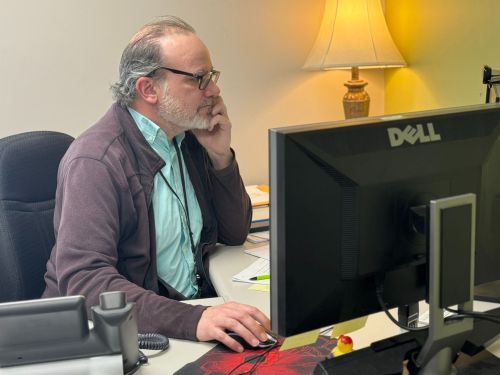 Admission specialist works at computer